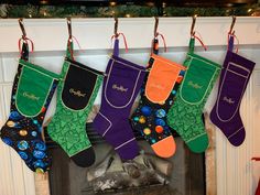 christmas stockings hanging from a mantel in front of a fireplace