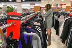 a woman is shopping in a clothing store