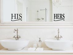 two sinks with the words his and her written on them in front of a mirror