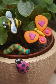 some little bugs sitting on top of a potted plant