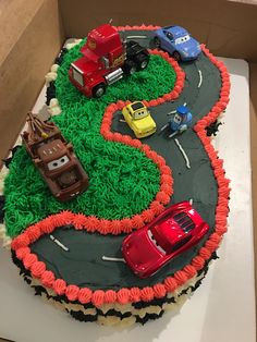 a birthday cake with cars on it in a box