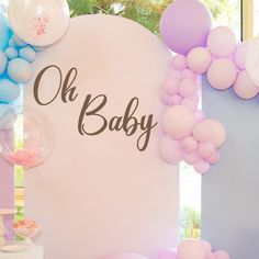 a baby shower with balloons and streamers on the wall next to it's name