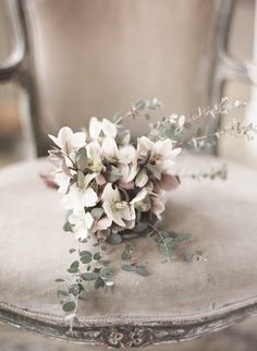 a bunch of flowers sitting on top of a chair