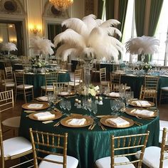 the tables are set with green linens and gold chargers