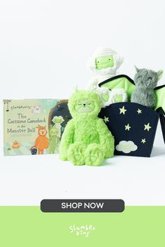 two stuffed animals sitting next to each other in front of a book with the title shop now