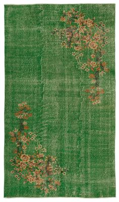 a green rug with flowers on it