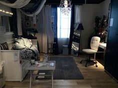 a living room filled with furniture and a chandelier hanging over the top of it