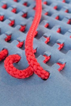 a red rope is laying on top of blue foam