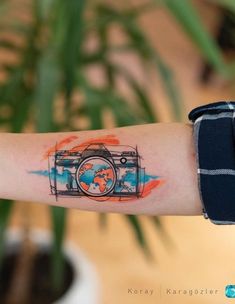 a person with a camera tattoo on their arm