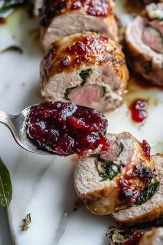 meatloaf stuffed with cranberry sauce and garnished with spinach leaves