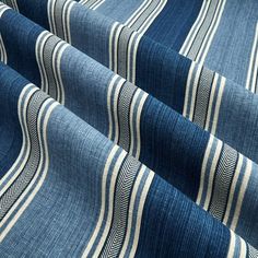 a blue and white striped fabric with vertical lines on the bottom, in an angled pattern