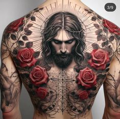 the back of a man with roses and jesus tattoo on his shoulder, behind him is a cross