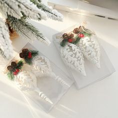 two christmas decorations are sitting on the table