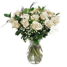 a vase filled with white roses and baby's breath