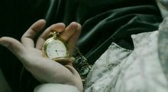 a person holding an old pocket watch in their hands