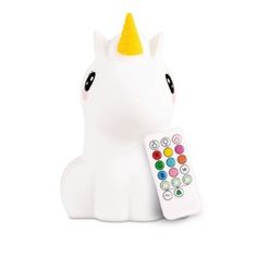 a white unicorn with a yellow horn and remote control next to it's head