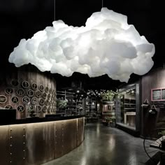 a large cloud hanging from the ceiling in a room with lots of lights on it