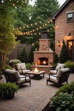 an outdoor patio with chairs, fire place and string lights strung over the brick fireplace