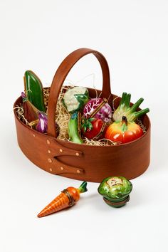 a wooden basket filled with assorted vegetables