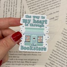 a person holding up a sticker that says the way to my heart is through the bookstore