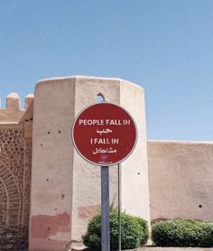 a red street sign sitting in front of a building