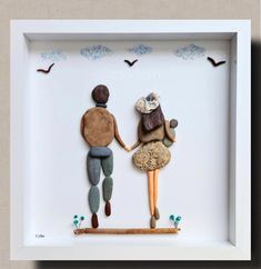 two people are holding hands in a shadow box