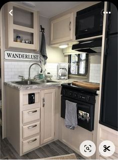 a kitchen with white cabinets and black appliances