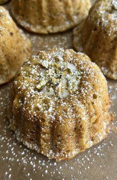 several pastries are covered with powdered sugar and sprinkles