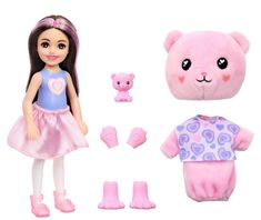 the doll is wearing a pink dress and has a teddy bear in her hand, as well as other accessories