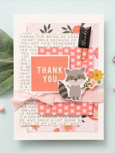 a handmade thank you card with a raccoon and flowers on the front