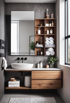 a bathroom with a sink, mirror and shelving unit in the middle of it