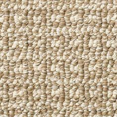 an up close view of the texture of a carpet with white and beige colors on it