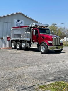 a red truck parked in front of a building