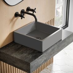 a bathroom sink sitting on top of a wooden counter next to a wall mounted faucet