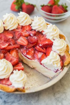 a pie with strawberries and whipped cream on top