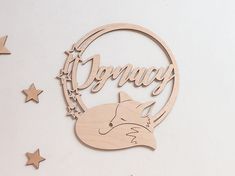 a wooden sign with the word fancy on it and a fox head surrounded by stars