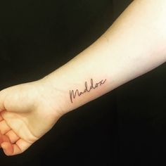 a woman's arm with a tattoo that reads madder on the side of it