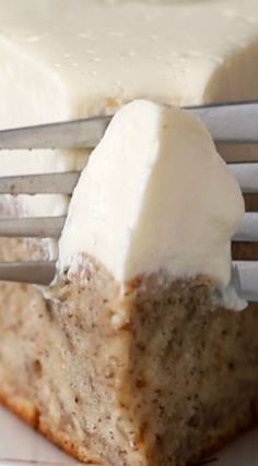 a piece of cake sitting on top of a white plate with a fork next to it