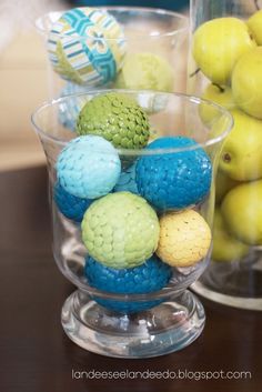 two glass bowls filled with different colored balls