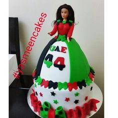 a birthday cake with a doll on top