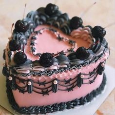 a heart shaped cake with blackberries on top