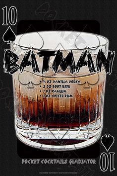 the batman cocktail is in a glass with black writing on it's bottom half