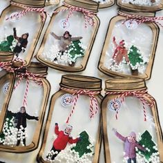 mason jars filled with miniature people and christmas decorations