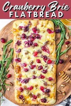 cranberry brie flatbread on a cutting board with rosemary sprigs