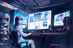 a woman sitting in front of two computer monitors