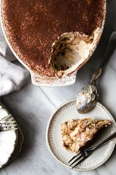 a piece of pie on a plate next to a fork and cake server with a slice missing from it