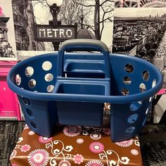 a blue plastic basket sitting on top of a table