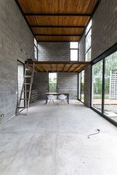 an empty room with ladders and tables in it