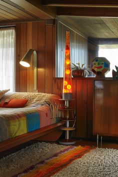 a bed room with a neatly made bed and a night stand next to a window