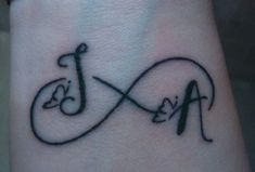 a tattoo on the wrist of a person with an infinite sign and music note in it